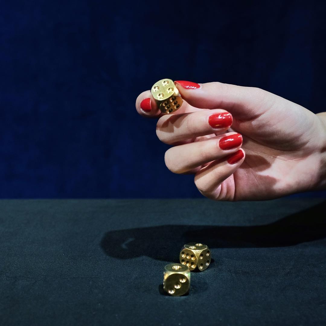 These dice are made for rolling. And made of solid brass: Shiny and with an unusual heavy feel in your hand. Image via Chop Suey Club NYC.